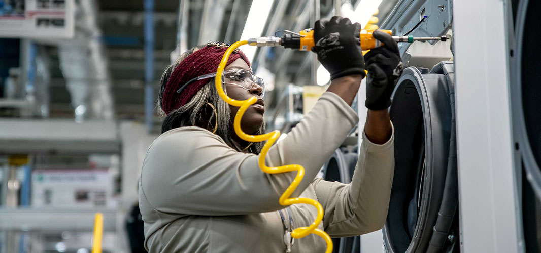 image of female worker assembling a washing machine in US LG factory