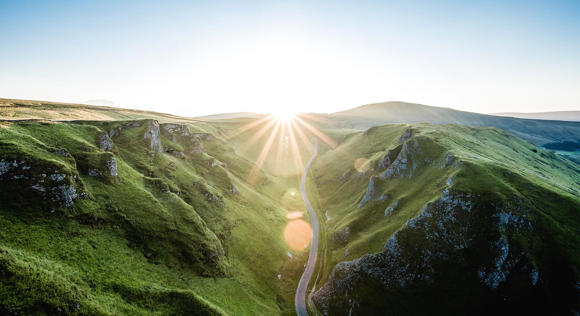 image of sun sets right at the top of the valley