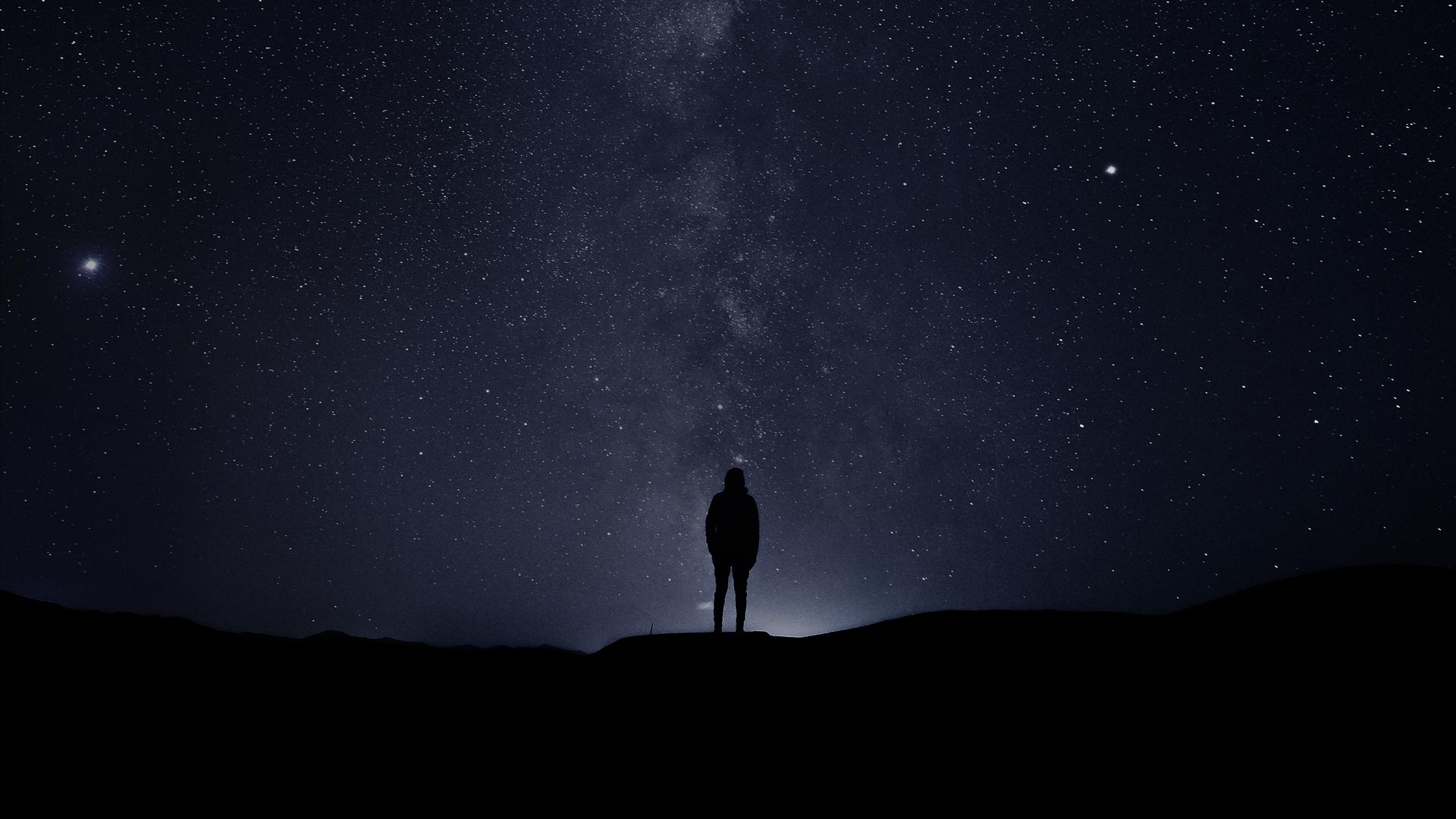 Silhouette of man against starry night sky