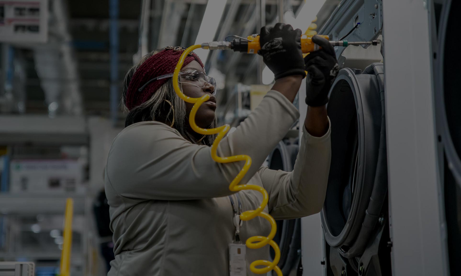 image of female worker assembling a washing machine in US LG factory