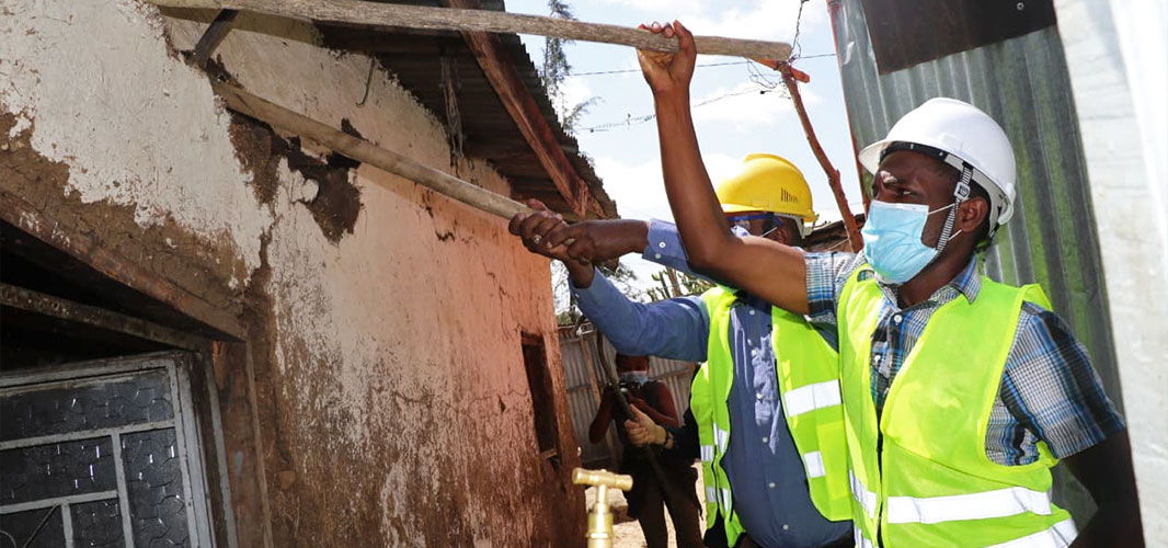 Ethiopian construction workers tearing down cracked walls for the Life’s Good: Hope Village campaign